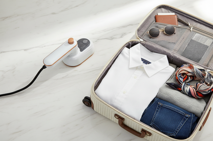 Krease white steam iron travel flatlay with suitcase